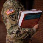 Veteran student holding textbooks
